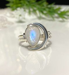 Vintage Sterling Silver Natural Moonstone Moon Ring ....Marked 925...Total of weights 3.2grams...Size 7...Measure of Face 14MMIt's in very good condition. Silver Oval Ring With Moon Phase, Silver Oval Rings With Moon Phase, Silver Oval Moon Phase Ring, Silver Moonstone Ring With Moon Phase, Celestial Style Silver Moonstone Ring, Unique Moonstone Ring With Moon Phase, Spiritual Sterling Silver Moonstone Ring With Moon Phase, Spiritual Open Ring Moonstone In Sterling Silver, Sterling Silver Crescent Moonstone Ring