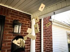 some papers are stuck to the side of a brick building and hanging from a post