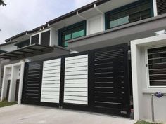 a black and white house with shutters on the front