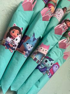 several toothbrushes with cartoon characters on them are lined up in the shape of umbrellas