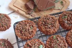 chocolate cookies cooling on a wire rack next to a cutting board with pieces of chocolate