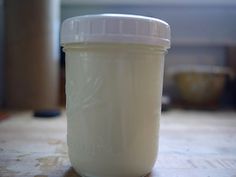 a glass jar sitting on top of a wooden table