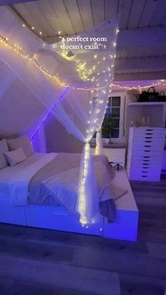 a bed with white sheets and lights on the headboard is lit up in purple