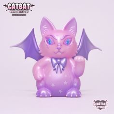 a pink cat with blue eyes and purple wings