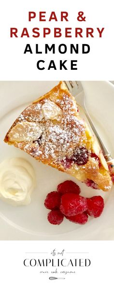 a white plate topped with a piece of cake and berries next to whipped cream on top of it