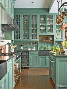 a kitchen with green cabinets and wooden floors is featured on the instagram for an article