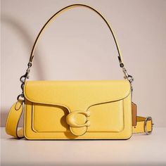 This Beautiful Tabby In Trendy Color Canary. A Modern Take On An Archival 1970s Coach Design, Our Structured Tabby Shoulder Bag Is Crafted Of Polished Pebble Leather. Finished With Our Tonal Leather-Covered Signature Hardware For An Iconic Touch, The Compact 26 Features Two Detachable Straps To Carry By Hand, Style As A Short Shoulder Bag Or Wear Crossbody. Authentic From Retail Coach. No Returns. Feel Confident Shopping From My Collection. Maybe Sold Out By Popular Demand. Stay Tune For More Fr Yellow Bags, Tabby Shoulder Bag, Hand Style, Stay Tune, Polished Pebble, Canary Yellow, Signature Hardware, Cute Purses, Trendy Colors