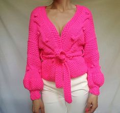 Description Hand knitted pink cardigan with belt. Unique pattern of my own production and design. COLOR -  Pink NOTE- Real color may slightly differ from one monitor to another as it depends on specific monitor settings. Bubbles are made separately and attached after knitting.   FIBER - Yarn - 100 % Acrylic SIZES -One size. Suitable to S and M. Width- 45 cm , length-54 cm. Sleeve width in shoulder-20 cm ,sleeve width in wrist-9 cm. Sleeve length-38 cm. Belt length-141 cm, belt width-4 cm  CARE - Gentle dry clean or gentle hand wash with a cold water and mild detergent. Minimize the amount of friction you use as you wash to avoid dislodging the pile. Rinse the throw with cold water and wring it out gently to drain the excess water. Lay flat to dry on some towel to absorb the extra water fro Black Crop Sweater, Cardigan With Belt, Unique Cardigan, Sweater Handmade, Sweater Ideas, Spring Cardigans, Belted Sweater, Business Board, Pink Jumper