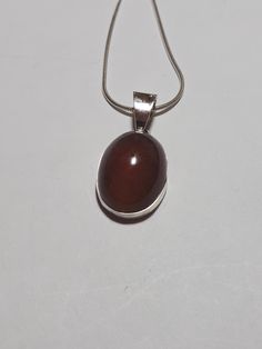 Baltic amber pendant.  From the Baltic sea.  Polish residents find amber on the shores of the sea after a storm, and gather it up, and cut and polish it into gemstones for jewelry and other uses. I have set this in the new highly tarnish resistant silver known as Argentium silver.  It is whiter and shines up brighter than regular sterling silver. I gift wrap all purchases.   I ship by USPS priority mail.  I ship in the US and Canada. Thank you for shopping at garysjewelry on Etsy. Amber Cabochon Oval Pendant Jewelry, Amber Cabochon Oval Pendant Necklace, Oval Baltic Amber Necklace As Gift, Oval Baltic Amber Necklace For Gifts, Spiritual Brown Oval Pendant Jewelry, Amber Oval Necklace With Large Pendant, Brown Hallmarked Jewelry As Gift, Brown Hallmarked Jewelry Gift, Hallmarked Brown Jewelry As Gift