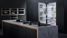 an open refrigerator in a kitchen next to a counter