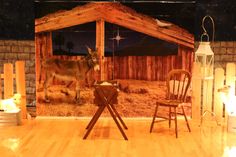 a wooden stage set with two chairs and a donkey