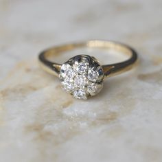 Vintage mid-century diamond cluster ring dating to about the 1950s. It has a raised design for a high-impact look. Each stone is about .05 ct for a ctw of .35 ct.  Era: c.1950s Markings: 14k, Makers mark (W in a diamond frame) Ring Size: 6.5 (your order comes with one free resizing by our jeweler) Condition: Excellent antique condition with minor surface wear from age  Shipping is free in the United States Follow on Instagram @LUXXORVintage Mid Century Ring, Classic 14k Gold Cluster Diamond Ring, Timeless Cluster Diamond Promise Ring, Cluster Ring With Brilliant Cut For Promise, Brilliant Cut Cluster Promise Ring, Anniversary Halo Setting Cluster Ring, Classic Brilliant Cut Cluster Diamond Ring, Classic Cluster Diamond Ring With Brilliant Cut, Classic Cluster Promise Ring