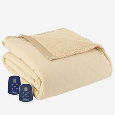 a blanket and two remote controls on a white background