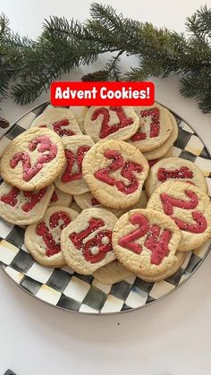 some cookies are on a plate with red letters