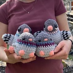 two small crocheted birds sitting on top of each other in their owners hands