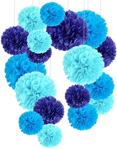 blue and purple tissue pom poms are hanging from the ceiling in front of a white background