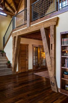 the inside of a house with wooden floors and stairs