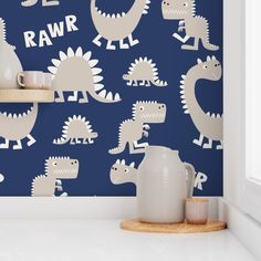 a blue wall with white dinosaurs on it