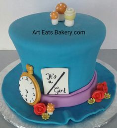 there is a cake that looks like a top hat with an alarm clock on it