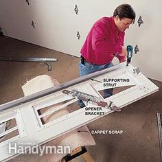 a man working on the side of a wall with screwdrivers and hammers