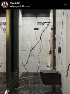 a bathroom with marble walls and flooring in black and white colors, including the toilet