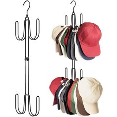 three hats are hanging on hooks and one hat is in the other handout holder