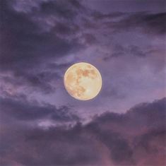 the full moon is shining brightly in the night sky with dark clouds and purple hues