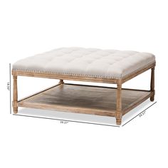 a wooden coffee table with a white cushion on top and measurements for the bottom shelf