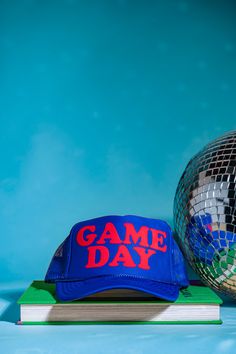 Prepare yourself in style for game day with this cheery cap, available in a range of color combinations. Looking for something more bespoke? Feel free to reach out to us and we'd be happy to accommodate you. Need a different color combo? Head over to our pick and print trucker! This hat is made to order and will ship in 3-5 business days MADE TO ORDER PRODUCTS ARE FINAL SALE Retro Snapback Hats For Game Day, Retro Game Day Cap, Retro Cap For Game Day, Blue Snapback Baseball Cap For Game Day, Blue Hat For Baseball Game Day, Game Day Sports Fan Cap, Sports Fan Cap For Game Day, Adjustable Blue Snapback Hat For Game Day, Sports Fan Hats For Baseball Season Game Day