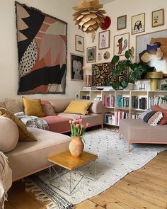 a living room filled with furniture and lots of pictures on the wall above it's bookshelf