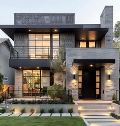 a modern house with steps leading up to the front door