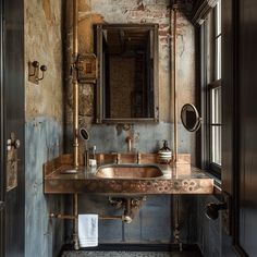 a bathroom sink sitting under a mirror in front of a window next to a brick wall