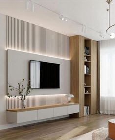 modern living room with white walls and wood flooring, large television on the wall