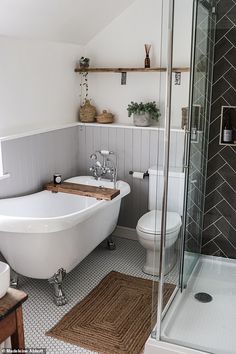 a white bath tub sitting next to a toilet in a bathroom