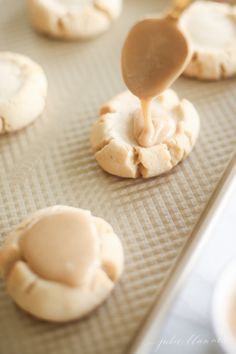 peanut butter cookies are being made on a baking sheet