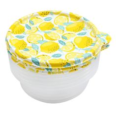 three plastic containers with lemons and leaves printed on the lids, sitting side by side