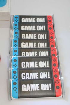 four game on stickers sitting on top of a white table next to a red and blue box