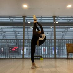 a person doing a handstand in an empty room