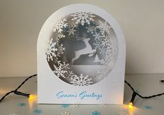 a card with a deer and snowflakes on it