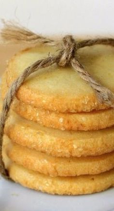 a stack of shortbread cookies tied with twine on top of a white plate