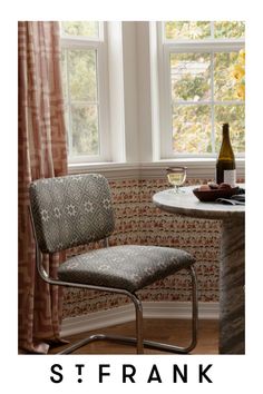 a chair and table in front of a window with the words st frank on it