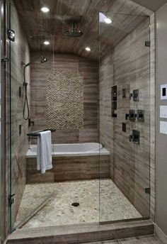 a walk in shower sitting next to a bath tub