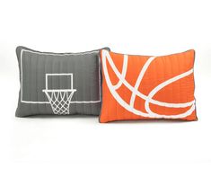 two pillows with basketballs on them sitting next to each other in front of a white background