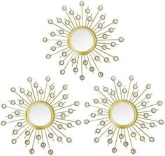 three gold mirrors with diamonds in the shape of sunbursts on white background