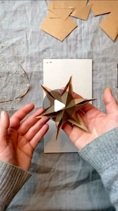 someone is making an origami star out of paper