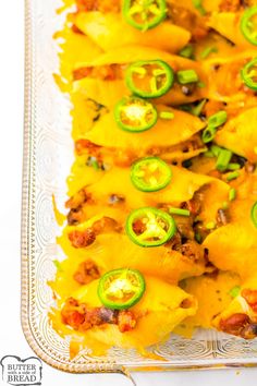 a casserole dish with cheese and green peppers on it, ready to be eaten