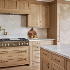 a kitchen with wooden cabinets and white marble counter tops