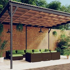 an outdoor living area with couches and potted plants