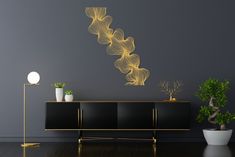 a black and gold sideboard in a room with a plant on the floor next to it