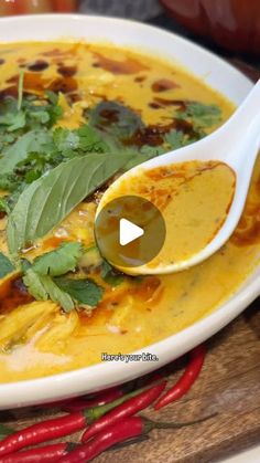 a white bowl filled with soup and garnished with herbs